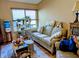 Cozy living room features natural light, neutral color, sofa, and window with blinds at 61 Osage Ct, Columbus, IN 47201