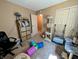 Living room with shelves, cat tree, complimented by a large window and office chair at 61 Osage Ct, Columbus, IN 47201