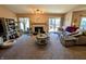 Large living room with fireplace, mantel, and access to the deck through the sliding glass door at 61 Osage Ct, Columbus, IN 47201