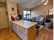 View from kitchen island to living room, featuring sofa, and vaulted ceilings at 61 Osage Ct, Columbus, IN 47201