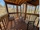Wooden deck surrounded by trees, complemented by patio furniture and natural light at 61 Osage Ct, Columbus, IN 47201