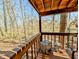 Wooden deck offering a view of the wooded area, complemented by patio furniture at 61 Osage Ct, Columbus, IN 47201