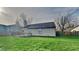 Spacious backyard featuring a wooden deck, grassy lawn, and partial fencing for privacy at 6508 Pergola Ln, Indianapolis, IN 46241