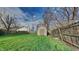 Well-maintained backyard with a storage shed, grassy lawn, and a wooden fence for privacy at 6508 Pergola Ln, Indianapolis, IN 46241