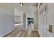 Inviting entryway showcasing hardwood floors, modern lighting, and a glimpse into the open-concept kitchen and living area at 6508 Pergola Ln, Indianapolis, IN 46241