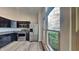 Stylish kitchen featuring stainless steel appliances, dark cabinetry, granite countertops, and natural light from the large window at 6508 Pergola Ln, Indianapolis, IN 46241