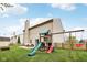 Large backyard with a play set, swing, slide, and patio, perfect for Gathering fun and outdoor activities at 6526 Angel Falls Dr, Noblesville, IN 46062