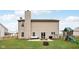Spacious backyard with a large lawn, play set, patio seating, and a fire pit perfect for outdoor activities at 6526 Angel Falls Dr, Noblesville, IN 46062