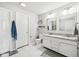 Clean bright bathroom featuring a double sink vanity and white cabinets, and decorative shelving above the toilet at 6526 Angel Falls Dr, Noblesville, IN 46062