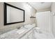 Bright bathroom featuring a granite countertop, a large mirror, and a shower with a white patterned curtain at 6526 Angel Falls Dr, Noblesville, IN 46062