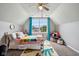 Comfortable bedroom with carpet, a window with blue curtains, and sloped ceilings at 6526 Angel Falls Dr, Noblesville, IN 46062