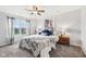Cozy bedroom features a ceiling fan, large window, and plush carpet, providing comfort and natural light at 6526 Angel Falls Dr, Noblesville, IN 46062