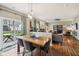 An open-concept dining area with a view of the backyard, wood floors, and access to a back patio at 6526 Angel Falls Dr, Noblesville, IN 46062
