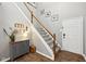 Stylish entryway with a carpeted staircase, decorative accents, and tile flooring at 6526 Angel Falls Dr, Noblesville, IN 46062