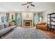 Cozy living room with a fireplace, hardwood floors, and inviting seating arrangements at 6526 Angel Falls Dr, Noblesville, IN 46062