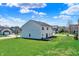 Backyard featuring a spacious lawn and a stone patio area at 6674 Buhrstone Ln, Avon, IN 46123