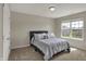 This bedroom features neutral walls, a large window and a comfortable-looking bed with decorative pillows at 6674 Buhrstone Ln, Avon, IN 46123