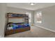 Bedroom showcasing bunk beds with colorful comforters and a window view at 6674 Buhrstone Ln, Avon, IN 46123