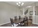 Open dining room area with dark wood table and staircase access featuring modern lighting at 6674 Buhrstone Ln, Avon, IN 46123