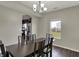 Dining room featuring a wood table with seating for six and views of the backyard through a bright window at 6674 Buhrstone Ln, Avon, IN 46123