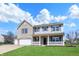 Charming two-story home featuring a covered front porch, a three-car garage, and a well-manicured lawn at 6674 Buhrstone Ln, Avon, IN 46123