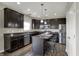 Stylish kitchen featuring dark cabinetry, stainless steel appliances, and a center island with bar stool seating at 6674 Buhrstone Ln, Avon, IN 46123