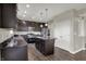 Kitchen showcasing dark wood cabinets, stainless steel appliances, a center island, and views to the dining room at 6674 Buhrstone Ln, Avon, IN 46123