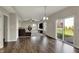 Bright living room with wood floors, sliding glass doors to the backyard, and modern furnishings at 6674 Buhrstone Ln, Avon, IN 46123