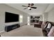 Stylish living room featuring modern entertainment center, large windows, and plush sectional sofa at 6674 Buhrstone Ln, Avon, IN 46123