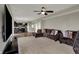 Open-concept living room connected to the kitchen, featuring plush seating and a modern entertainment center at 6674 Buhrstone Ln, Avon, IN 46123