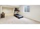 Bright basement featuring a home gym area with a treadmill and natural light from a window at 6707 Meadow View Ct, Avon, IN 46123