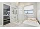 Bathroom featuring freestanding tub, glass shower, and view into bedroom area at 6707 Meadow View Ct, Avon, IN 46123