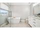 Bright bathroom with a freestanding tub, a white vanity with marble top, and modern fixtures at 6707 Meadow View Ct, Avon, IN 46123