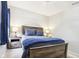 Carpeted bedroom with a wooden bed frame, side tables with lamps, and a window at 6707 Meadow View Ct, Avon, IN 46123