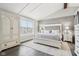Cozy bedroom features a white bed, neutral walls, wood-look floors, a window, and built-in wardrobe at 6707 Meadow View Ct, Avon, IN 46123