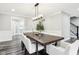 A dining room features a decorative light fixture and a long wood table, alongside white chairs and molding accents at 6707 Meadow View Ct, Avon, IN 46123