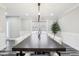 Bright dining room with a long wooden table, stylish chairs, neutral walls, and a window with a decorative blind at 6707 Meadow View Ct, Avon, IN 46123