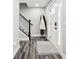 Welcoming entryway with wood-look floors, coat rack, and staircase to upper level at 6707 Meadow View Ct, Avon, IN 46123