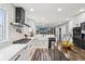 Bright kitchen featuring stainless appliances, an island, a farmhouse sink, white cabinets, countertops, and backsplash at 6707 Meadow View Ct, Avon, IN 46123