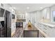 Kitchen with stainless appliances, white cabinets, wood grain flooring, and a mini fridge at 6707 Meadow View Ct, Avon, IN 46123