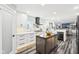 Open concept kitchen with stainless appliances, white cabinets and countertops, wood grain floors, and center island at 6707 Meadow View Ct, Avon, IN 46123