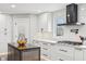 Well-lit kitchen featuring white cabinets, stainless appliances, an island, and a window overlooking the outdoors at 6707 Meadow View Ct, Avon, IN 46123