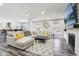 Bright living room features a fireplace, large sectional, and modern decor at 6707 Meadow View Ct, Avon, IN 46123