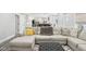 Spacious living room with open view to the kitchen area with grey ottomon at 6707 Meadow View Ct, Avon, IN 46123