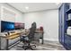 Bright office space featuring dual monitors, a modern desk, stylish chair, and sleek blue built-in storage at 6707 Meadow View Ct, Avon, IN 46123