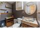 Bathroom featuring vanity, decorative mirror, toilet and dark colored walls at 6853 Cordova Dr, Indianapolis, IN 46221