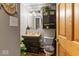 Cozy bathroom featuring a round mirror, plant accents, and a dark vanity with ample storage space at 6853 Cordova Dr, Indianapolis, IN 46221