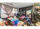 Untidy bedroom with dark colored wall and items stacked on bed at 6853 Cordova Dr, Indianapolis, IN 46221