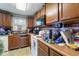 Traditional kitchen featuring wood cabinets, dated appliances, and a functional layout for cooking at 6853 Cordova Dr, Indianapolis, IN 46221