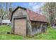 A wooden backyard shed with a roll up door and decorative touches at 6853 Cordova Dr, Indianapolis, IN 46221